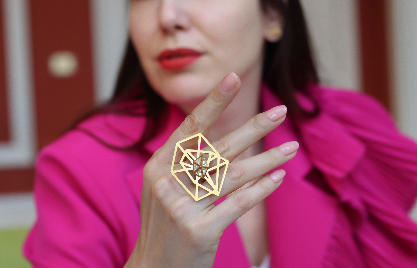  Katerina Perez wears the Shattered ring by Robert Guild in brushed 18k yellow gold with reverse-set round brilliant-cut diamonds 