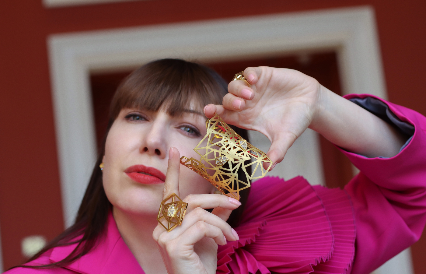  Katerina Perez showcases pieces, including a statement ring and cuff bracelet from the new Shattered collection by Robert Guild, crafted in brushed 18k yellow gold with reverse-set diamonds 