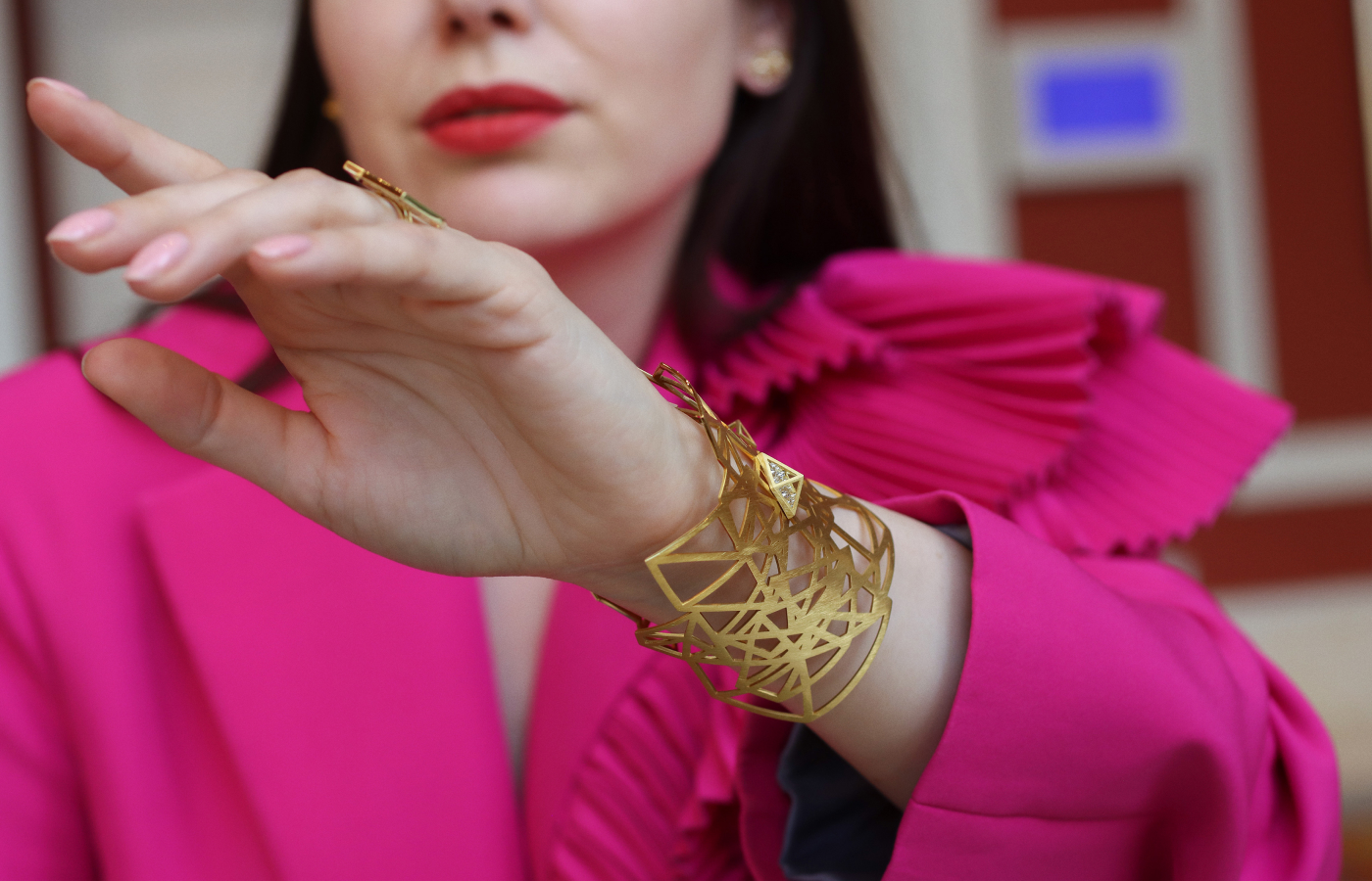  Katerina Perez wears the Shattered cuff bracelet by Robert Guild crafted in brushed 18k yellow gold with 50 reverse-set round brilliant-cut diamonds totalling 1.20 carats 