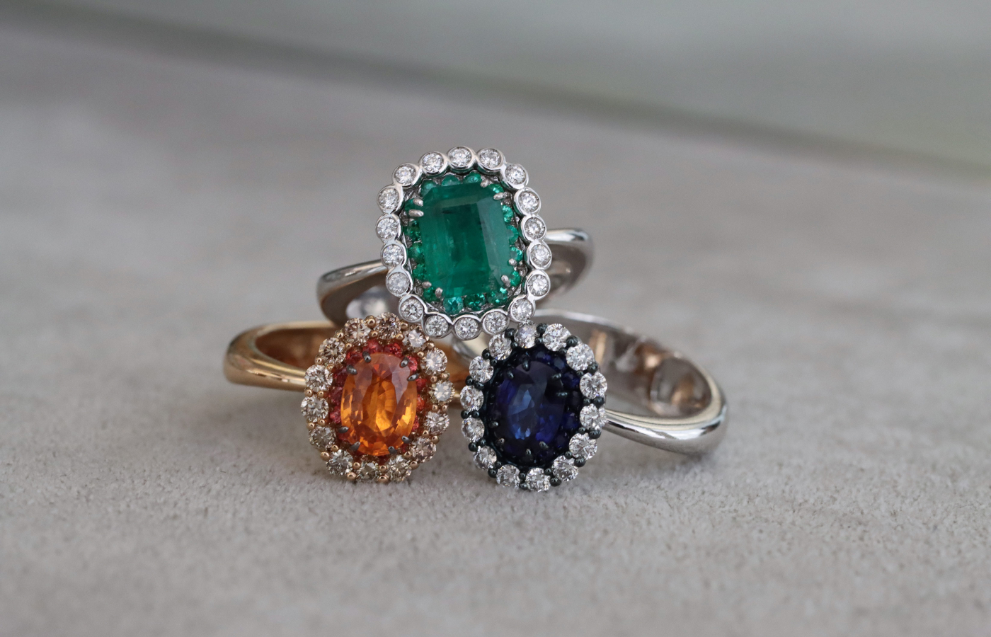 A trio of rings from the Essentials collection by Daverio1933, including a 1.17 carat mandarin garnet ring with orange sapphires and brilliant-cut brown diamonds 