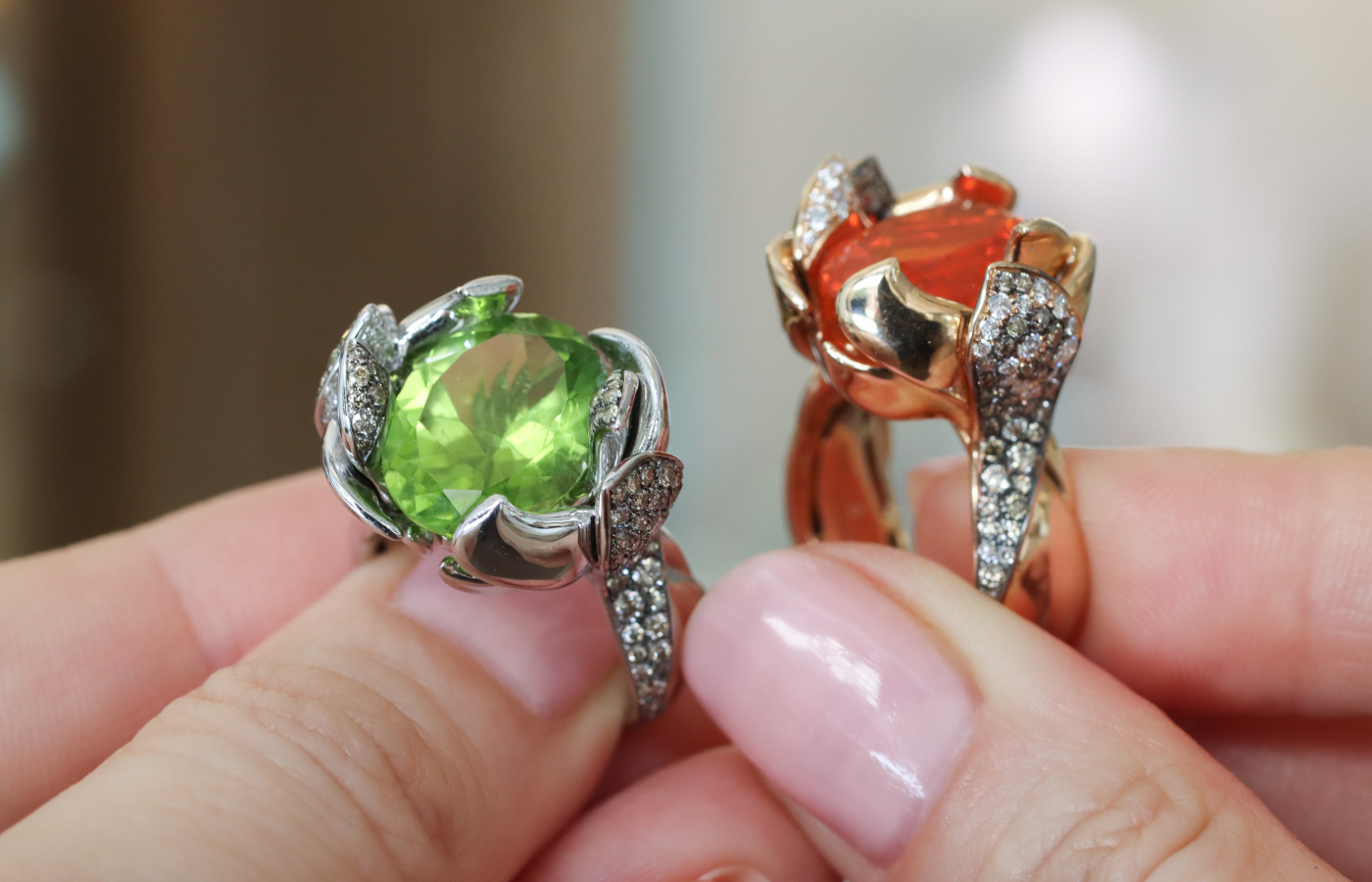 Calafate rings from the Daverio1933 Masterpieces collection, including one with a 7.02 carat peridot, further peridots, diamonds and brown diamonds, set in 18k white gold, and a second with a 3-carat fire opal, brown diamonds and white diamonds, set in 18k rose gold 