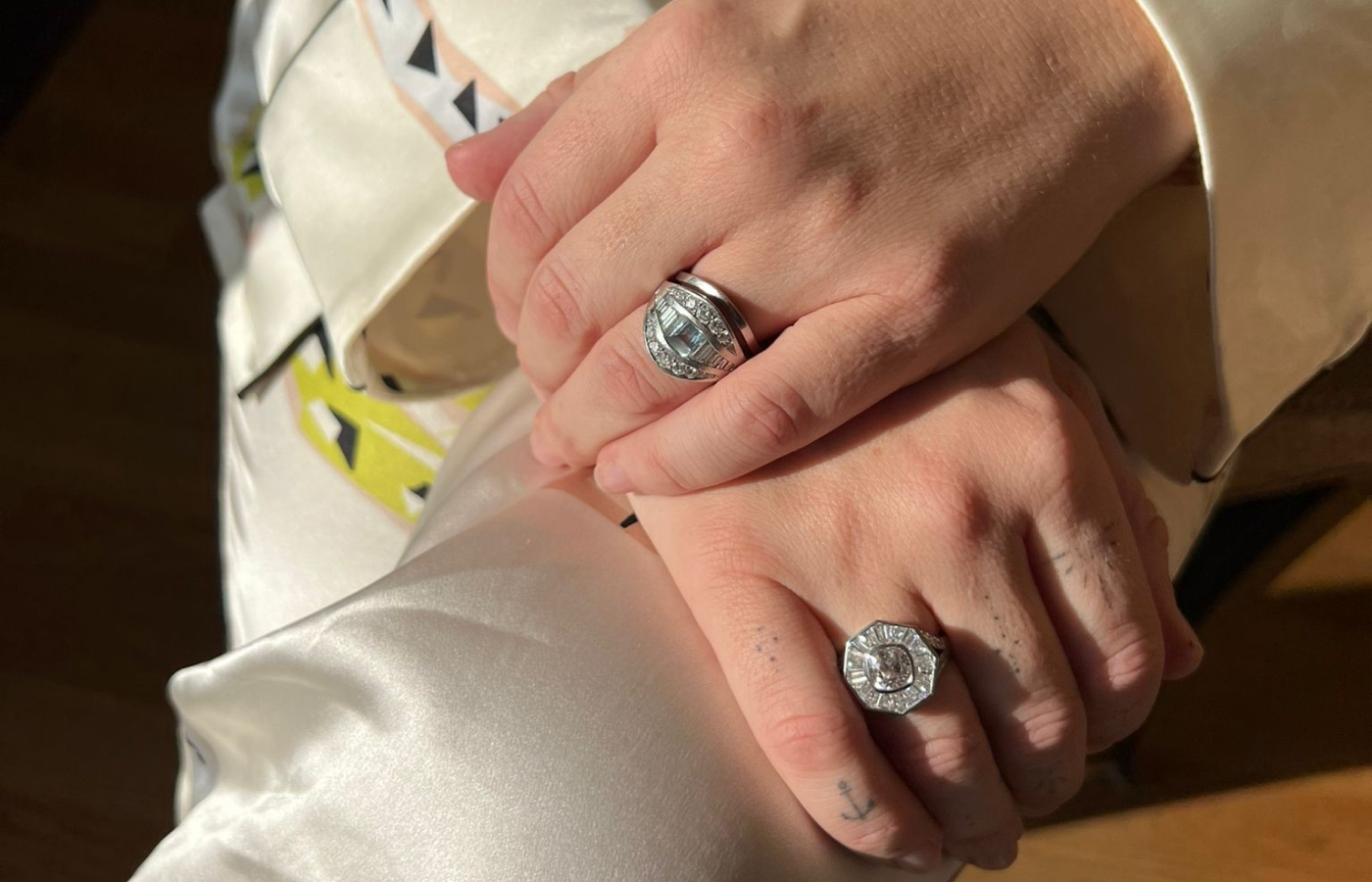  Ellie wearing the Hattie Rickards’ bespoke Halo ring, crafted with a brilliant-cut heirloom diamond along with custom-cut tapered baguettes and carré-cut diamonds, set in white platinum