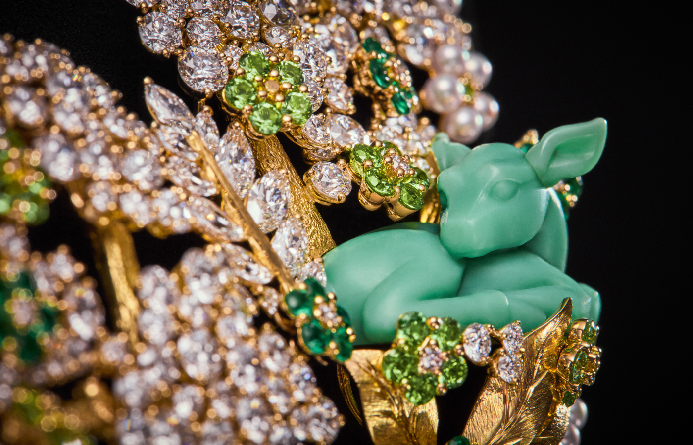  A carved three-dimensional chrysoprase ‘resting deer’, crafted using the technique of glyptic arts, surrounded by diamonds, emeralds, tsavorite garnets, and pearls, all set in engraved 18k yellow gold, part of the Diorama Forêt Enchantée set from the Diorama & Diorigami High Jewellery Collection