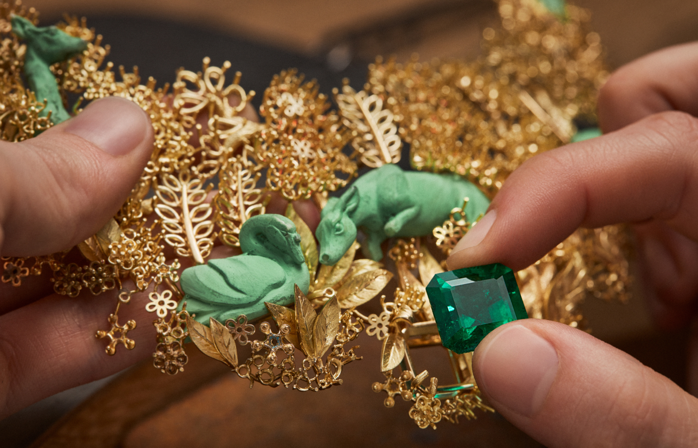  Diorama Forêt Enchantée Necklace in the making, featuring a glyptic chrysoprase swan and deer, and incorporating a 16.16-carat Colombian emerald, set in engraved 18k yellow gold, part of the Diorama & Diorigami High Jewellery Collection