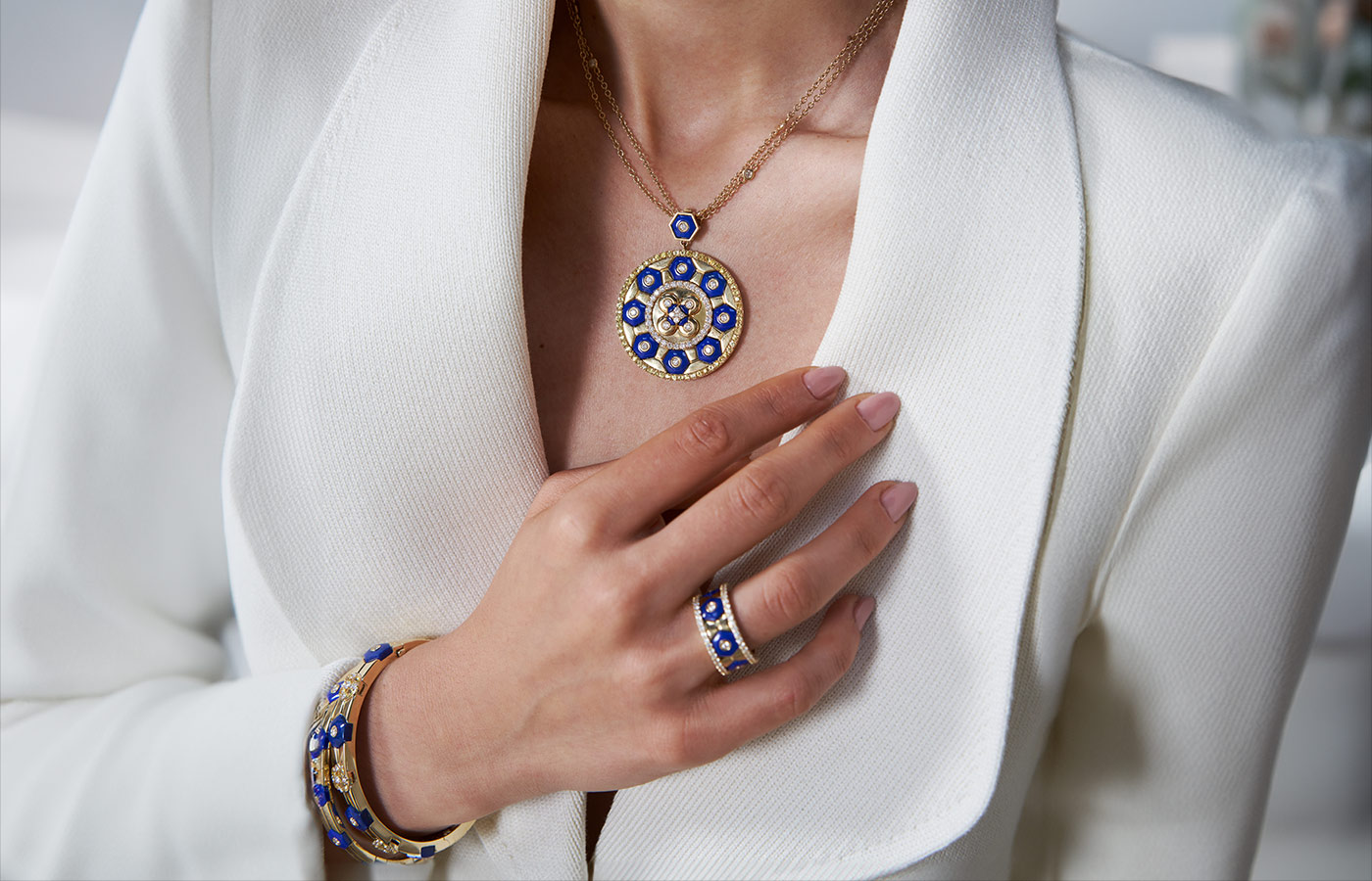  A model wears a Miseno Baia lapis lazuli pendant with 1.76 carats of white diamonds and 2.11 carats of yellow sapphires alongside a Baia lapis lazuli band ring, a duo of bangles with lapis lazuli, white diamonds and yellow sapphires 