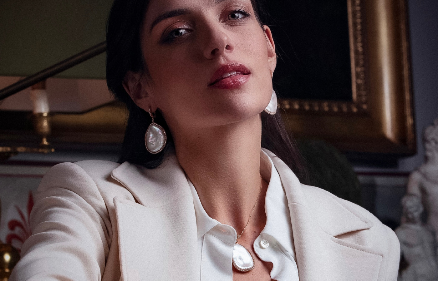 Model wears Coscia earrings with South Sea baroque pearls and diamonds in 18k gold from the Couture collection