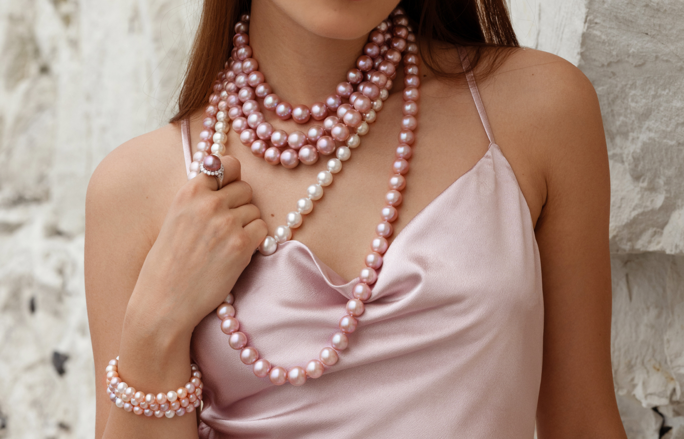  Model wears a Yoko London necklace with pearls & diamonds in 18k rose gold from the classic collection, paired with a Yoko London ring with pearls and diamonds in 18K gold from the Duchess collection