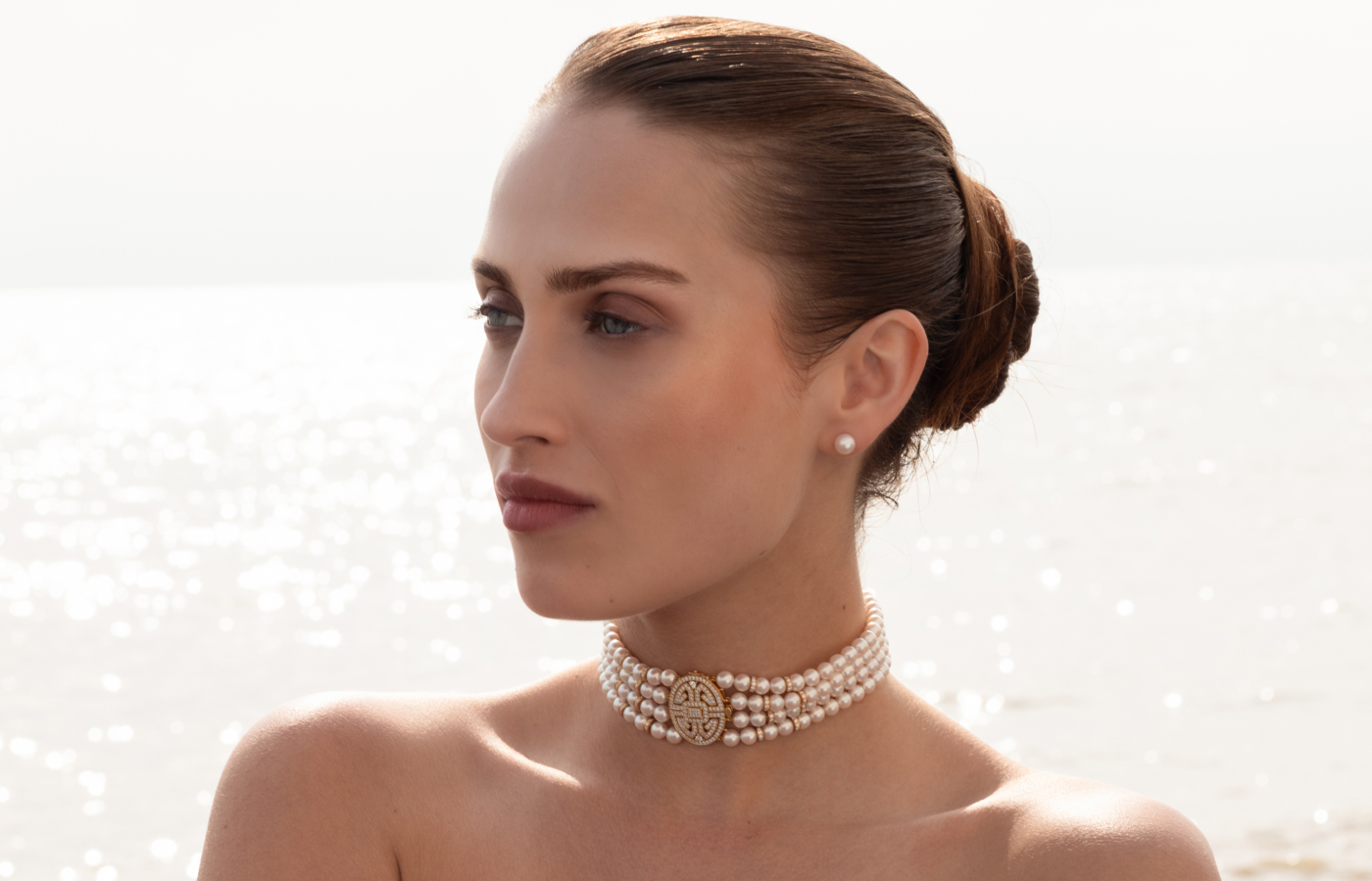  Model wears a Yoko London choker  with Akoya pearls in 18k yellow gold, from the Classic collection