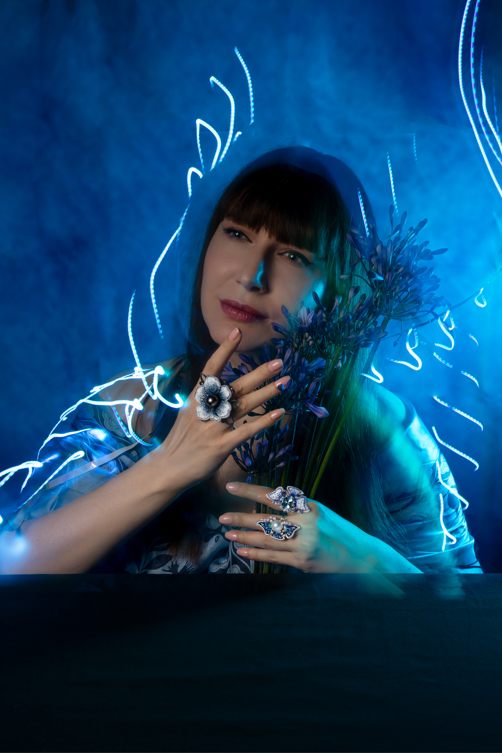 <p>Katerina Perez wears cocktail rings by Sicis, including (right hand) the Printemps De L’Ocean ring with 1.63 carats of white diamonds, 2.27 carats of black diamonds, and Tahitian pearl, the (left hand) Anemone Sea ring with 1.72 carats of diamonds and an Australian South Sea pearl, and the Anemone Aqua ring (index finger) with 1.74 carats of diamonds, a 3.46 carat aquamarine, and blue sapphires, all with signature micromosaics in18k white gold</p>