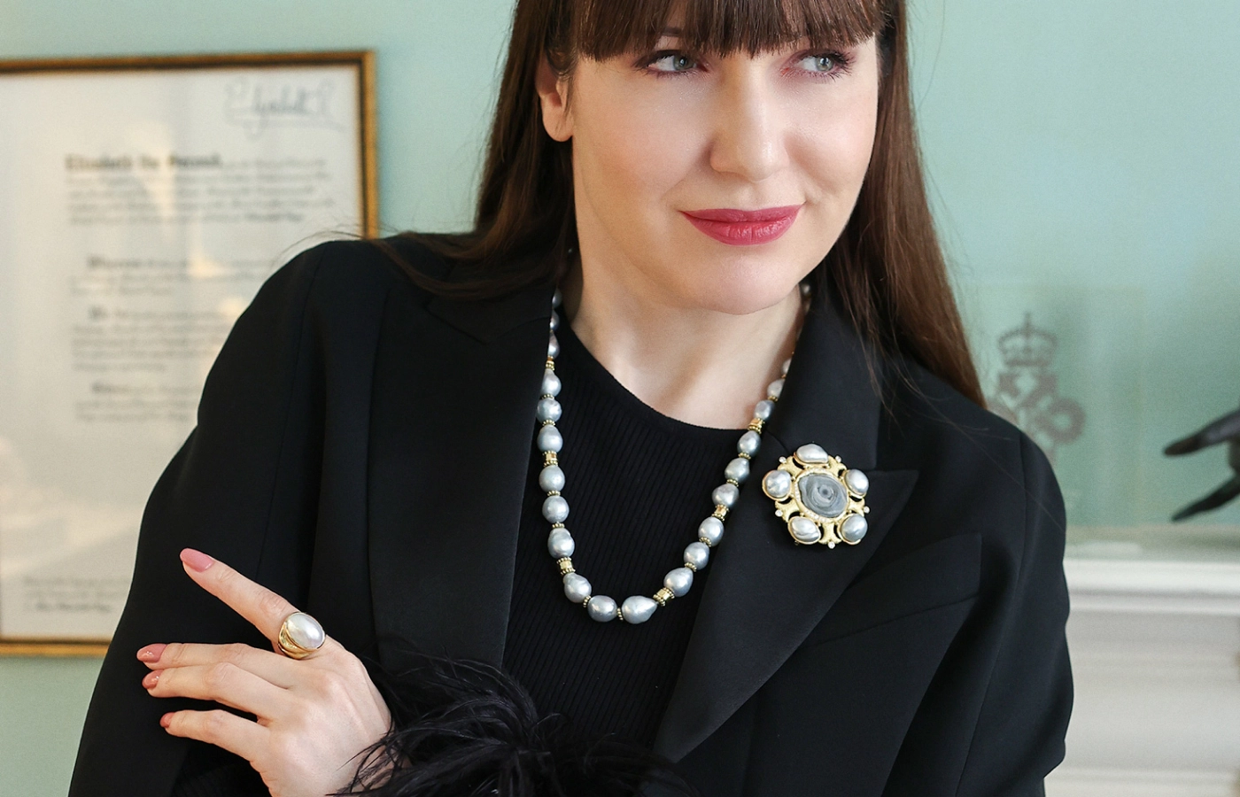  Katerina Perez wears jewellery by Elizabeth Gage, including a necklace with 31 cultured South Sea pearls, a pin with a chalcedony rose, five baroque South Sea grey pearls and brilliant-cut diamonds, and a pearl ring, all set in 18k yellow gold 