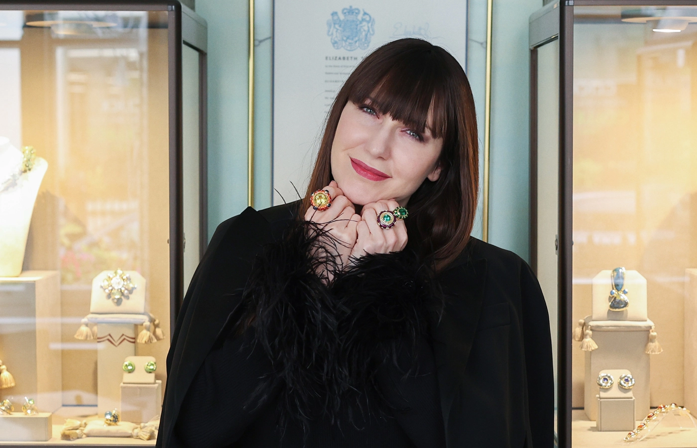  Katerina Perez wears rings by Elizabeth Gage including (from left to right) the Ottoman ring with a 17.17 carat yellow beryl, a second Ottoman ring with a 4.6 carat Paraiba tourmaline, and a Charlemagne ring with a 5.72 carat green tourmaline, all in 18k yellow gold 