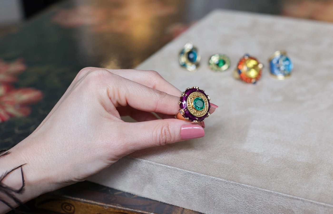 Elizabeth Gage Ottoman ring with a 4.6 carat oval-shaped Paraiba tourmaline, six round brilliant-cut diamonds and purple enamel in 18k yellow gold