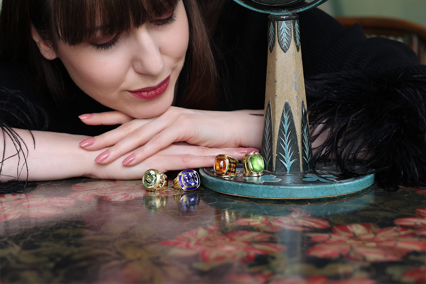  Four cocktail rings by Elizabeth Gage, including (from left to right) a Charlemagne ring with a 17.70 carat mint green tourmaline, a Charlemagne ring with an 11.67 carat tanzanite, the Aramis ring with a 15.80 carat sugarloaf mandarin garnet, and a Templar ring with a 22.64 carat peridot, all in 18k gold 
