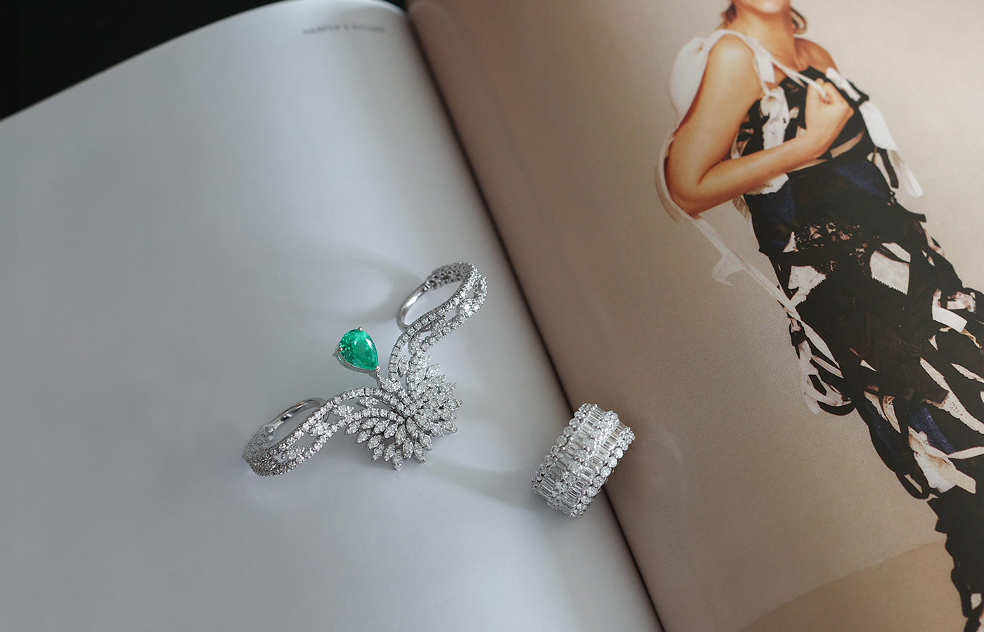  Hassanzadeh Jewellery Timeless Verdure two-finger ring with a 2.13 carat pear-shaped emerald and 2.90 carats of diamonds alongside the Thick Diamond band with 3.81 carats of round diamonds and 7.55 carats of emerald-cut diamonds 