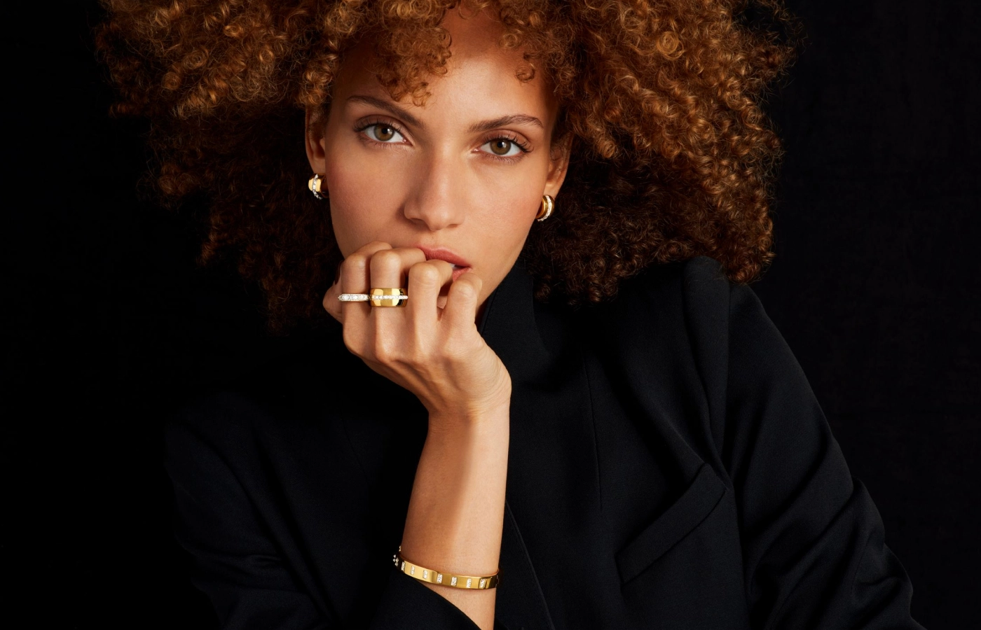 Model wears Pragnell earrings, rings and bracelet from the RockChic collection with diamonds in 18k yellow gold