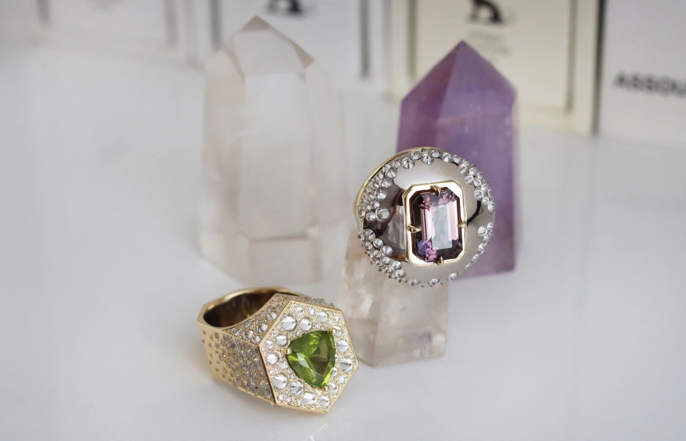 Hugo Cahill Perseya Lumen ring (left) with a 3.05 carat peridot and reverse-set diamonds and the Ophiuchi ring with a 5.08 carat tanzanite and reverse-set diamonds, both in 18k palladium white gold and 18k gold from the Renaissance High Jewellery collection