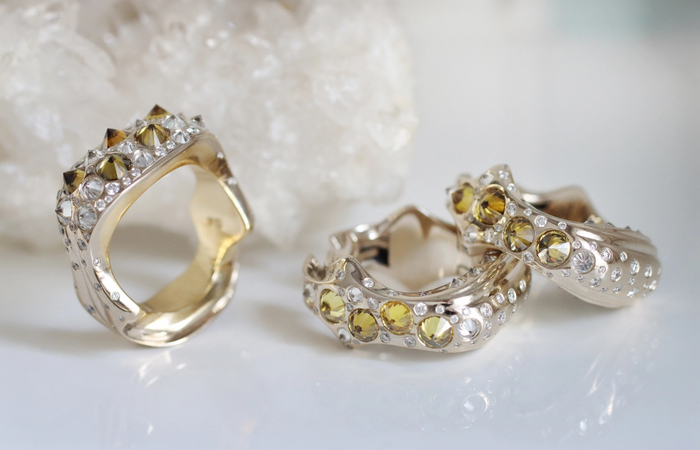 Hugo Cahill Maar Spiked ring (left) and the Tephra Spiked earrings from the Renaissance High Jewellery collection with reverse-set white and yellow diamonds in brown and orange hues in 18k palladium white gold and 18k gold and 18k beige gold, respectively 