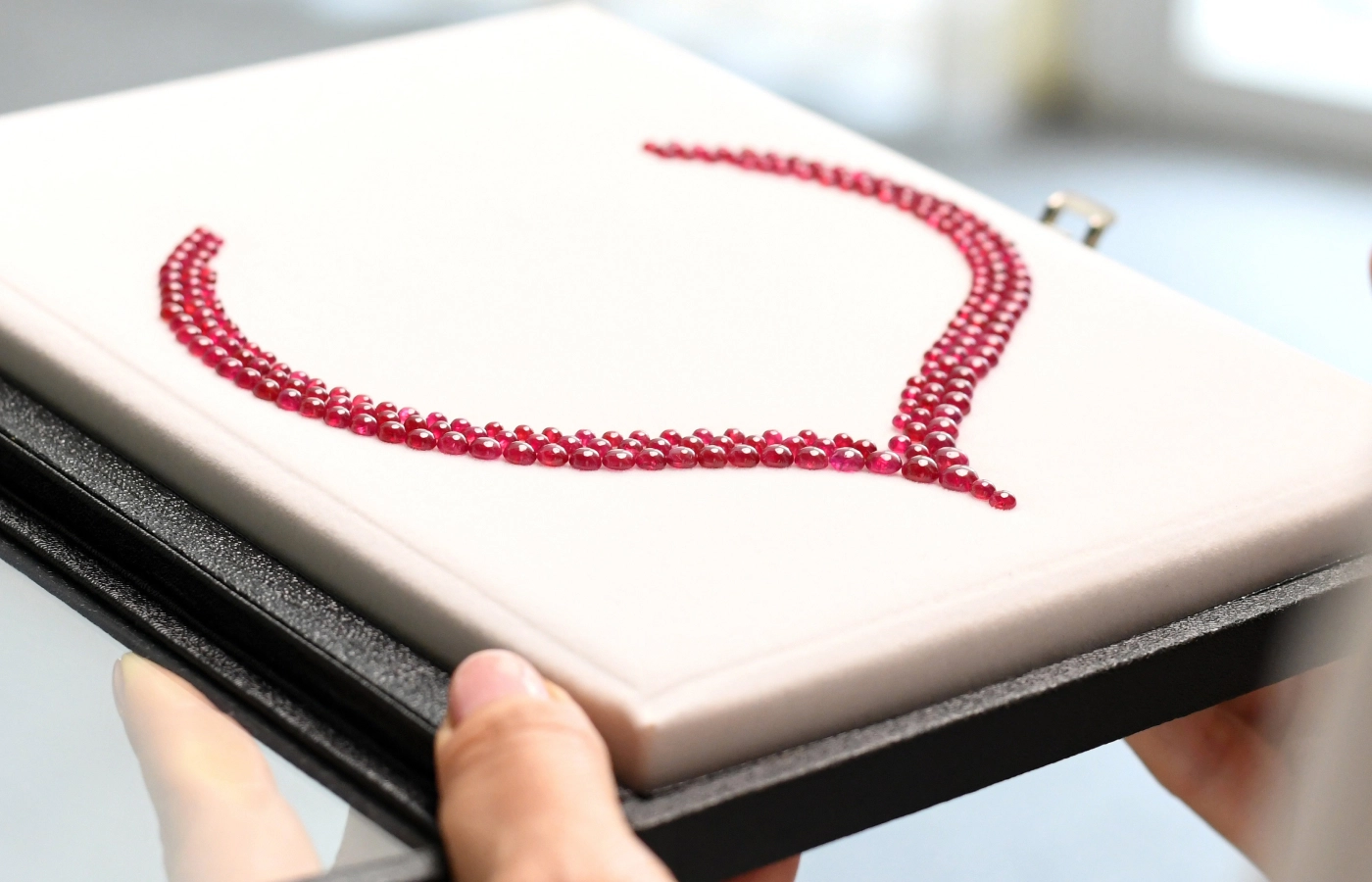  Cabochon rubies perfectly matched by colour and carat weight to form a necklace layout