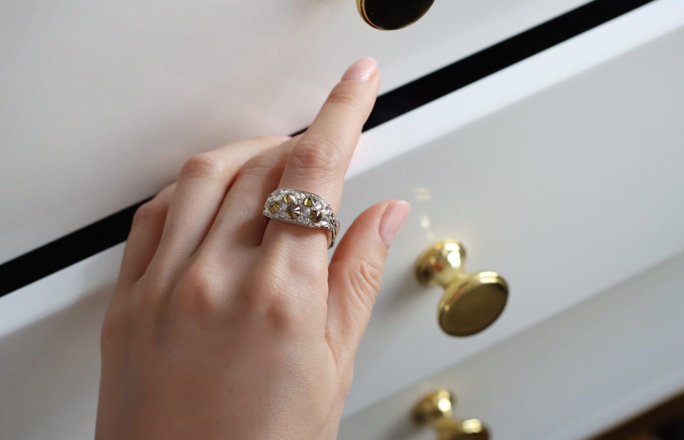 Model wears a Hugo Cahill ring with yellow and white diamonds in 18k white and yellow gold