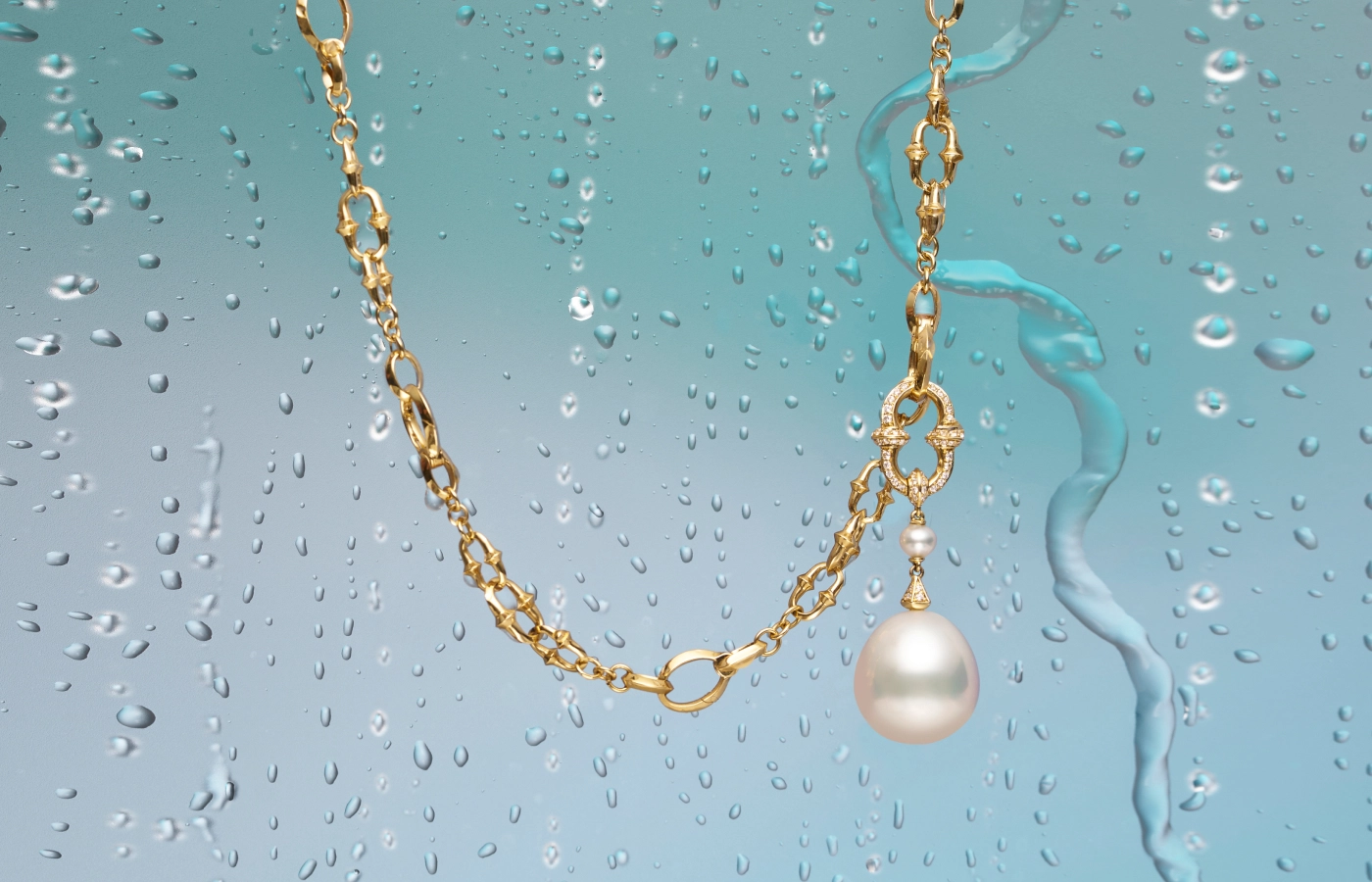  Paspaley Dive Chain necklace from the Dive collection with an attached Diamond Anchor Link pearl pendant featuring a Keshi baroque Australian South Sea pearl and white diamonds, both in 18k yellow gold 