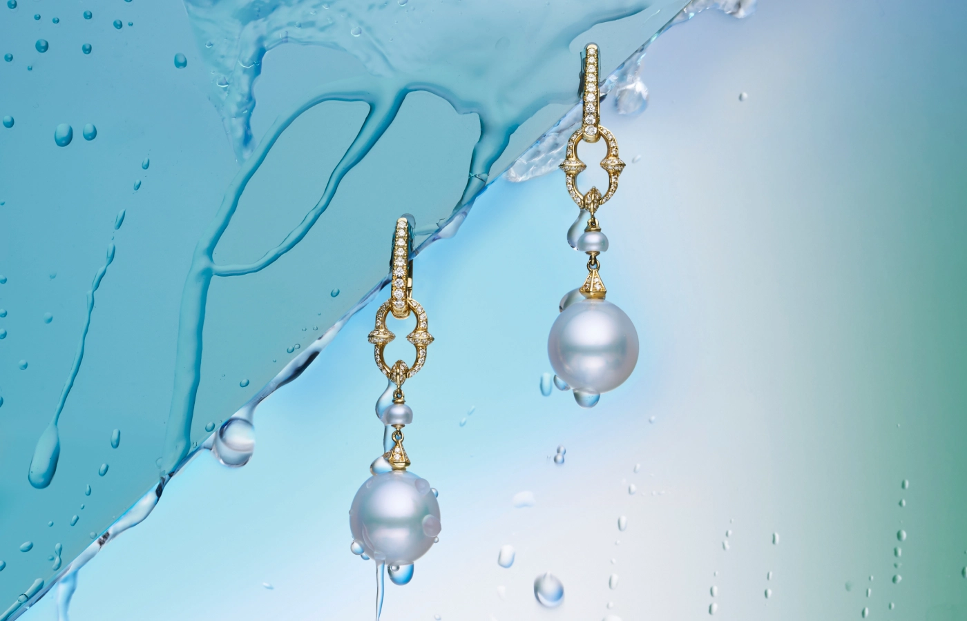  Paspaley Diamond Sea Buoy pearl earring enhancers with semi-round Australian South Sea pearls and white diamonds from the Dive collection, pictured here with diamond-set ear clips, both in 18k yellow gold 