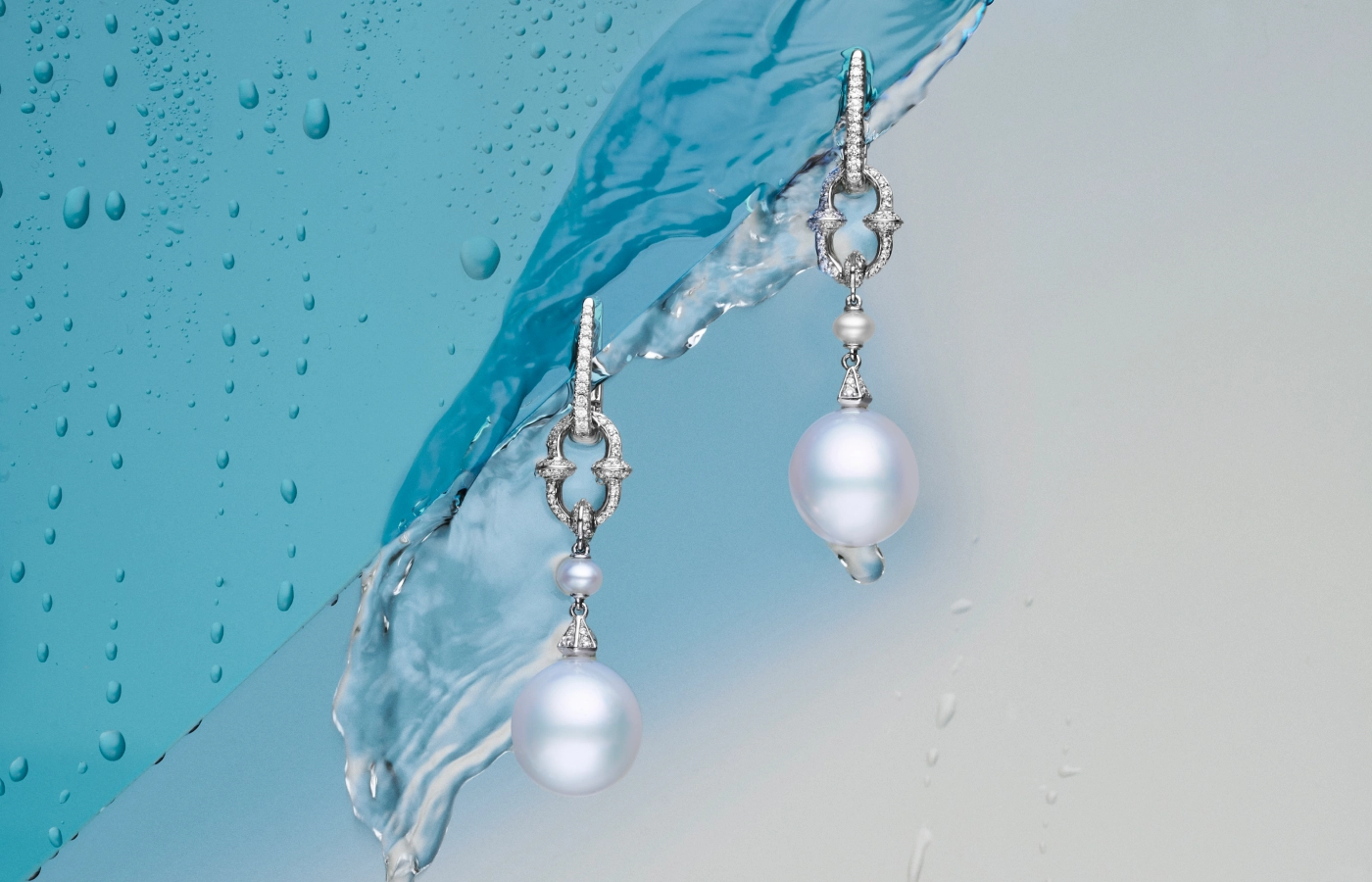  Paspaley Diamond Anchor Link pearl earring enhancers with Keshi baroque Australian South Sea pearls and white diamonds from the Dive collection, pictured here with diamond-set ear clips, both in 18k white gold 