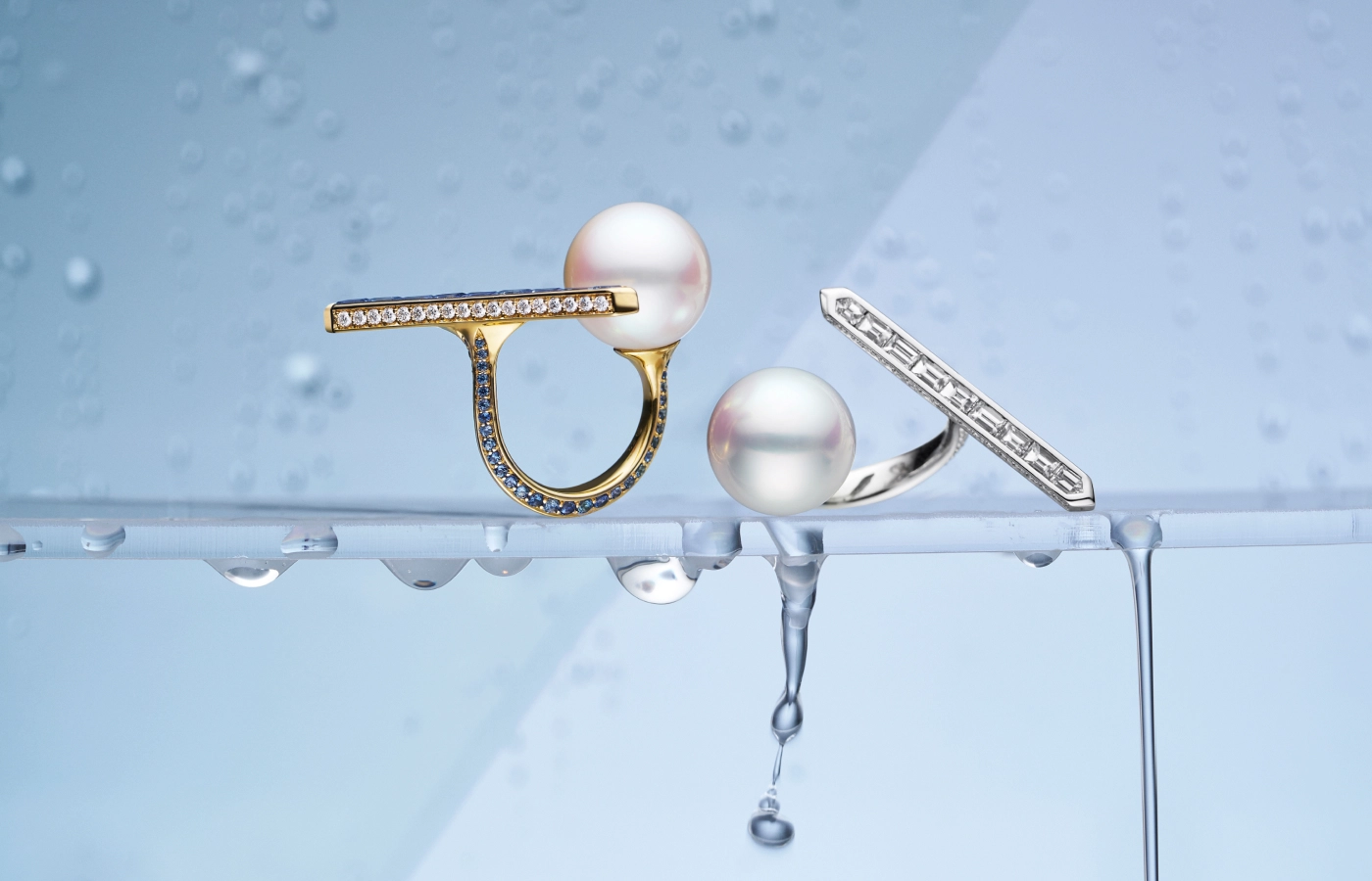 Paspaley Bollard Split pearl rings from the Dive collection with 14mm semi-round Australian South Sea pearls, blue sapphires and white diamonds in 18k yellow gold (left) and white diamonds in 18k white gold (right)