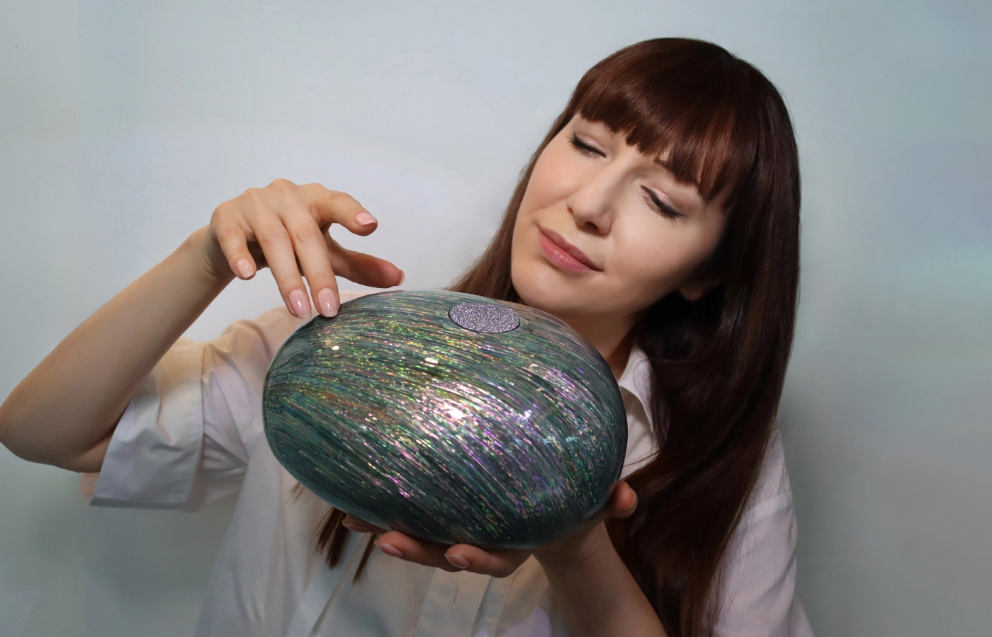 Katerina Perez holds a unique art piece inlaid with crystalline osmium by Park Ju Bin and Hwang Sam Yong