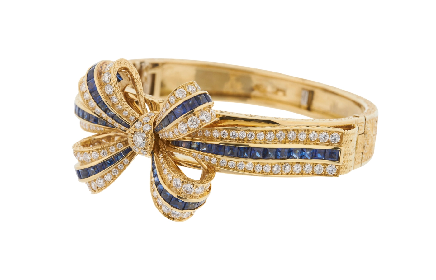  Fratelli Piccini Ribbon bracelet, designed by Armando Piccini in the 1950s, features hand-engraving in 18k yellow gold with calibrated carré diamonds and sapphires