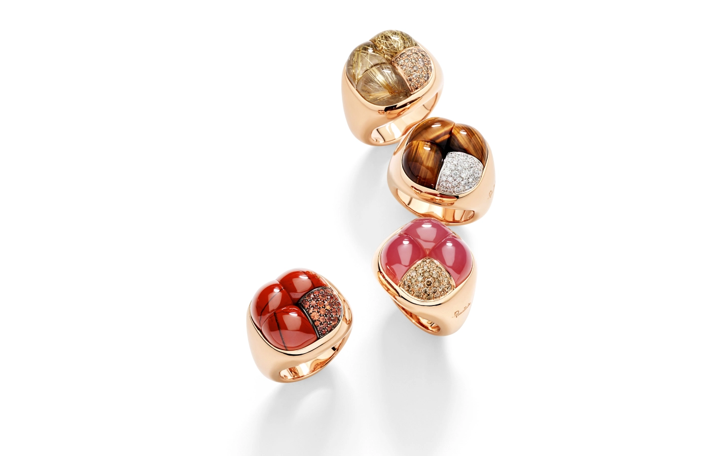  Pomellato Mosaico collection rings with rutilated quartz and brown diamonds, tiger’s eye and diamond (top),  garnet and brown diamonds, red jasper and orange sapphires (bottom), all set in rose gold