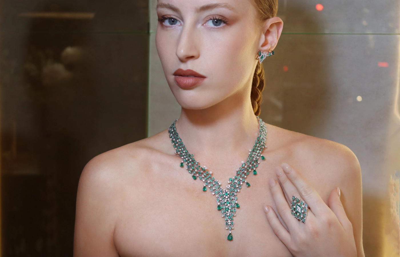  A model wears the Sicis Losange Emeraude set, including a necklace, ring and earrings in white gold with emeralds and diamonds at the opening of the Sicis boutique in Paris