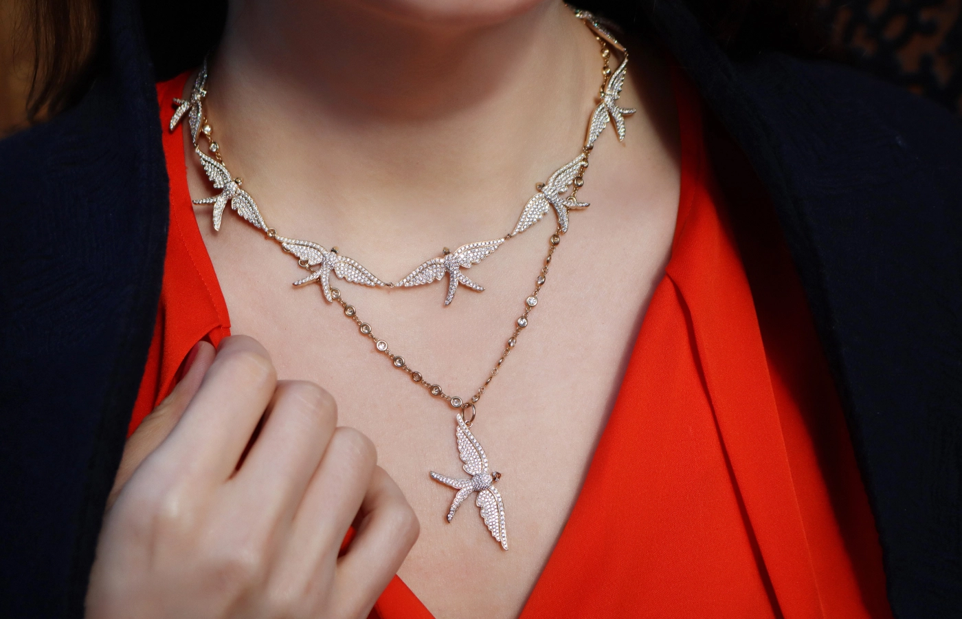  Katerina Perez wears the Lionheart Wings of Love Diamond Swallow charm, seen here on a chain necklace, and the Wings of Love Diamond Swallow necklace with seven repeating bird motifs and 5.65 carats of diamonds, both in 14k yellow gold 