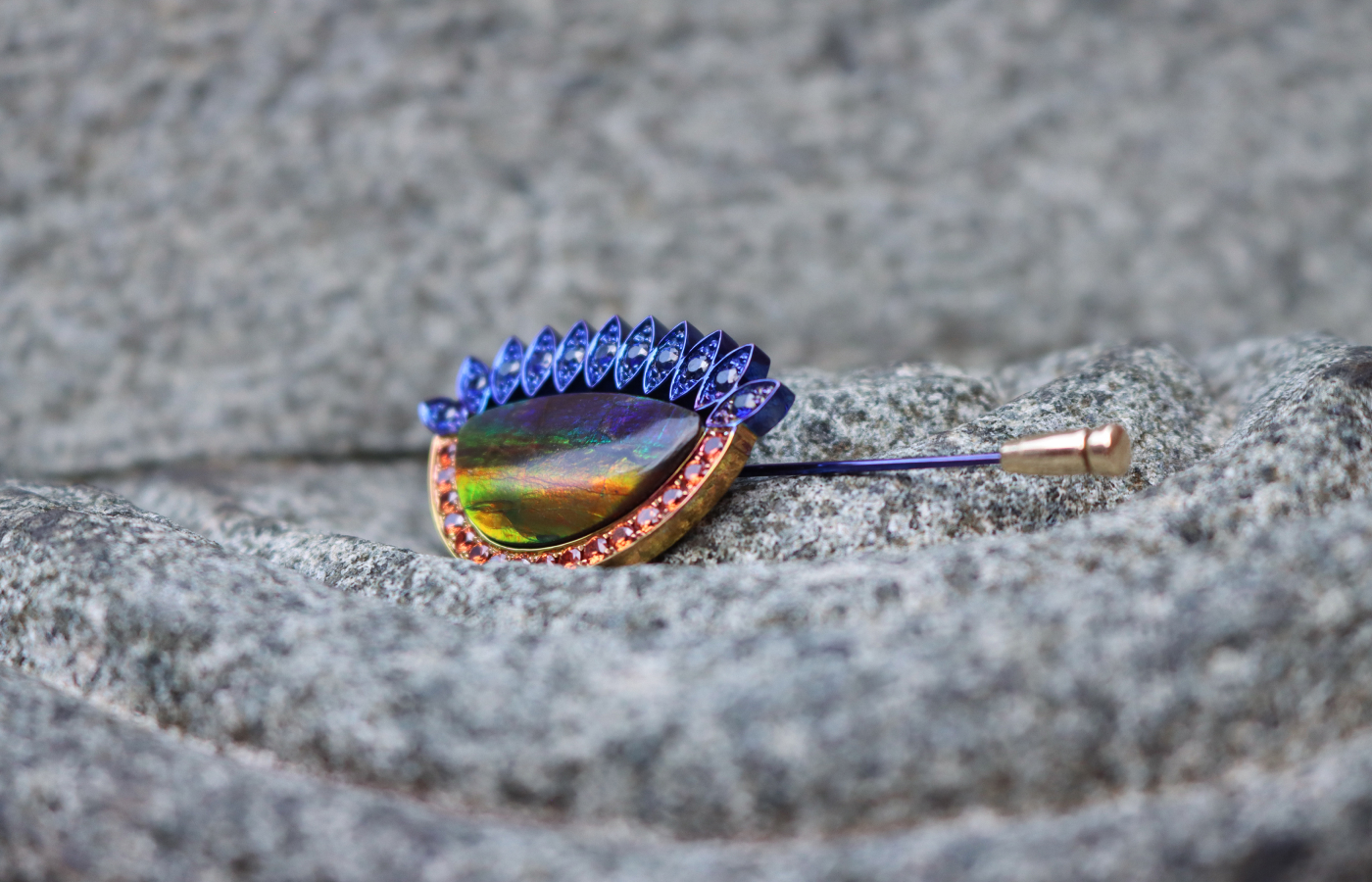  Susana Grau Batlle Evolution through Time ‘Time 1’ pin with a 12.34 carat ammolite, 16 round-cut orange sapphires, and 11 round-cut blue sapphires set in titanium and 18k yellow gold, part of the A Trilogy of Evolution High Jewellery collection