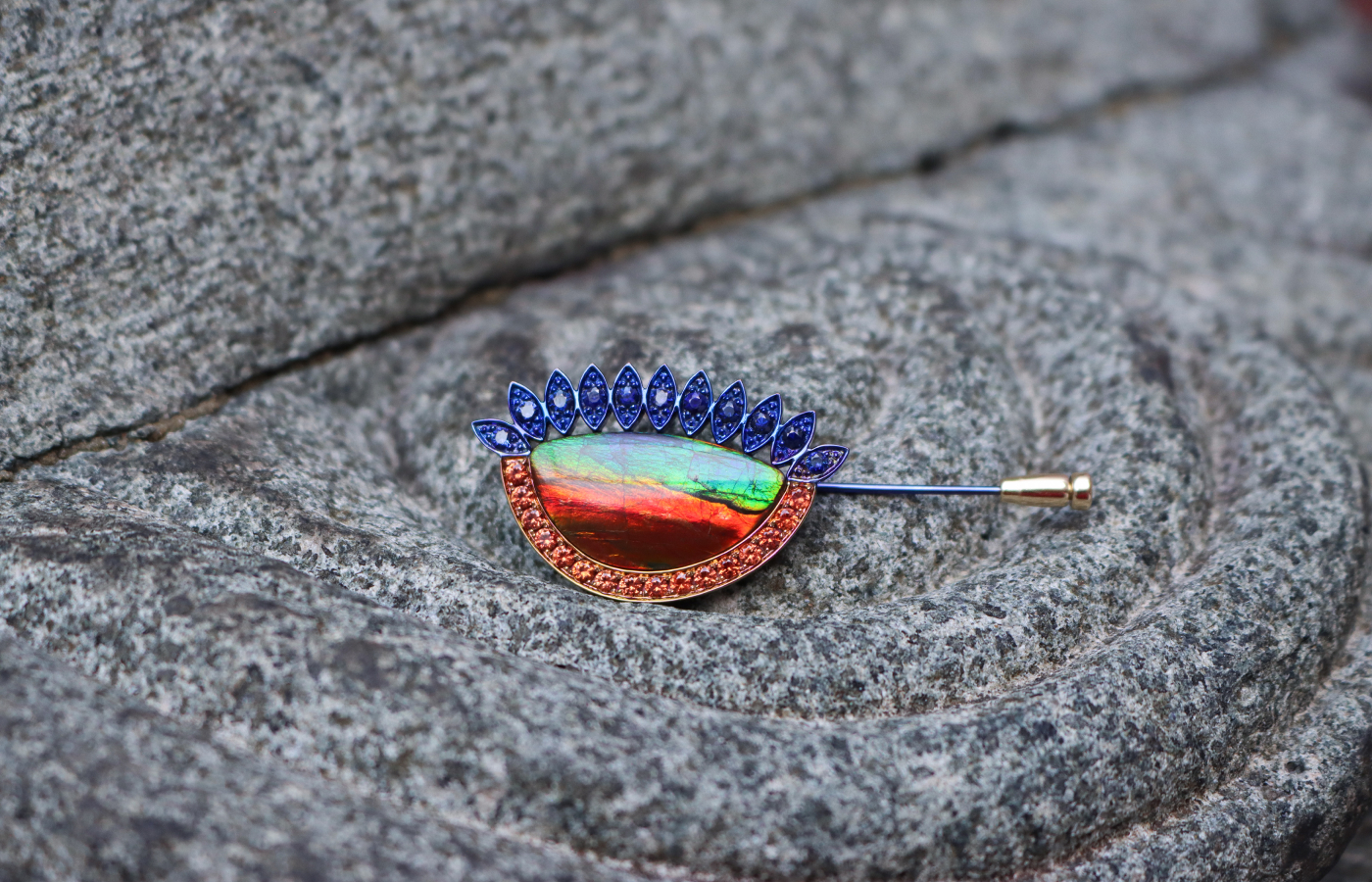  Susana Grau Batlle Evolution through Time ‘Time 1’ pin with a 12.34 carat ammolite, 16 round-cut orange sapphires, and 11 round-cut blue sapphires set in titanium and 18k yellow gold, part of the A Trilogy of Evolution High Jewellery collection