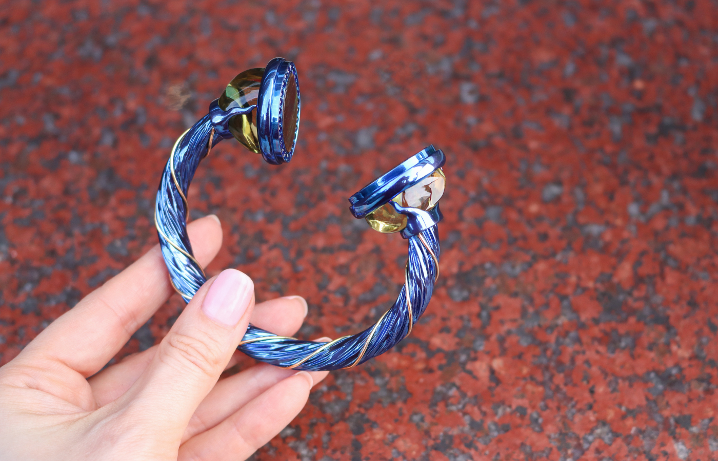  Susana Grau Batlle Evolution through Time ‘Time 2’ cuff with two ammolite of 17.52 carats, 2 citrines of 95.51 carats, and 47 round-cut blue sapphire of 2.71 carats, set in titanium and 18k yellow gold, part of the A Trilogy of Evolution High Jewellery collection