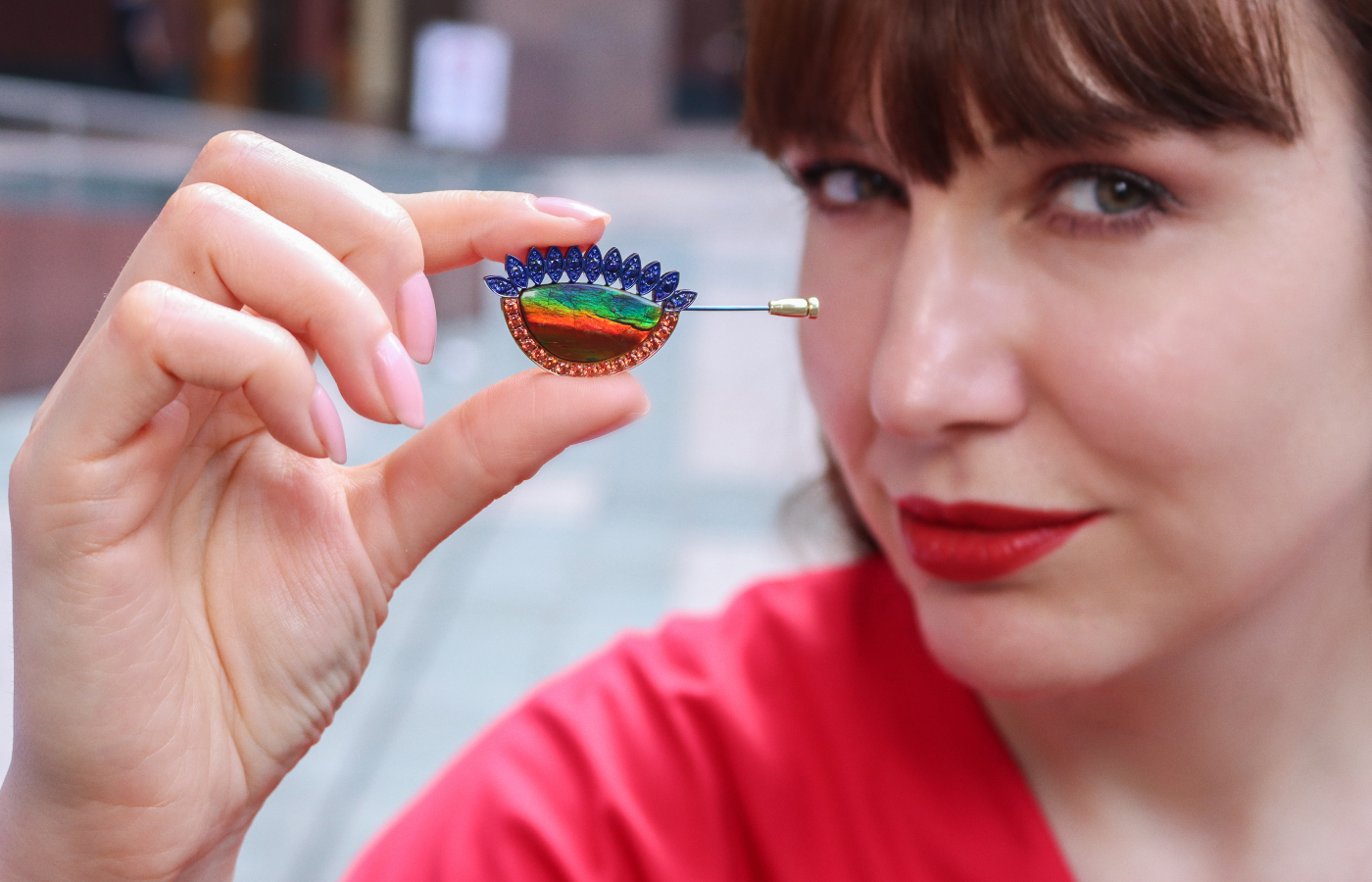 Katerina Perez holds the Susana Grau Batlle Evolution through Time ‘Time 1’ pin with a 12.34 carat ammolite, 16 round-cut orange sapphires, and 11 round-cut blue sapphires set in titanium and 18k yellow gold, part of the A Trilogy of Evolution High Jewellery collection
