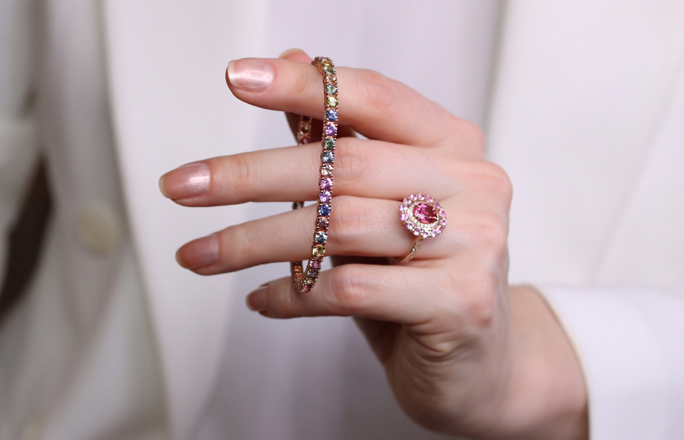  Morebelli tennis bracelet with 46 multi-coloured sapphires from Madagascar with a total weight of 9.51 carats, shown here alongside a pink tourmaline and pink sapphire ring 