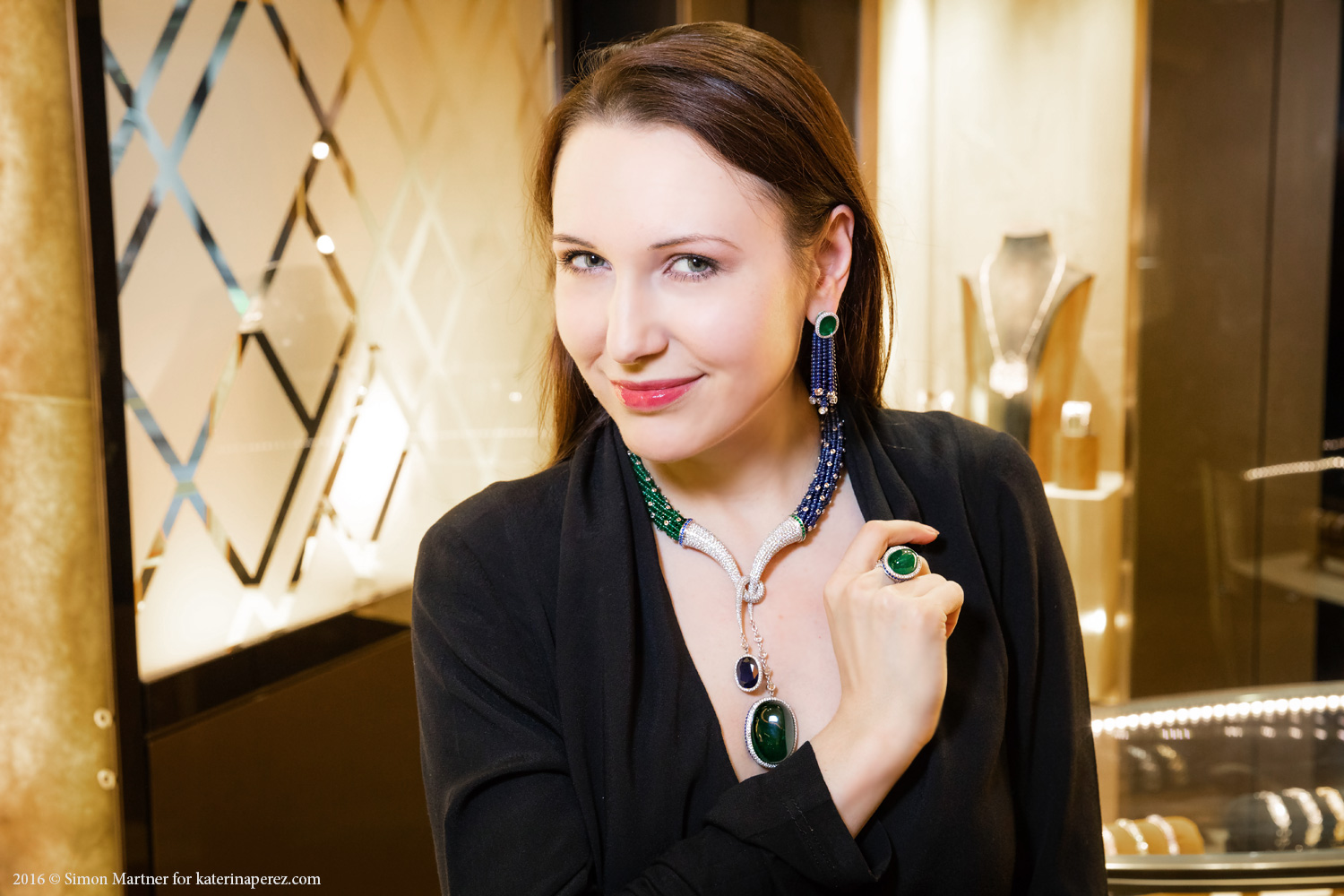 Katerina Perez wearing Avakian high jewellery necklace and earrings and a ring with sapphires, emeralds and diamonds