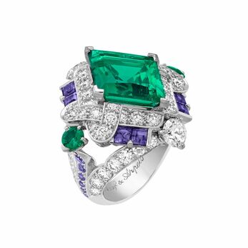 Amore Trionfante ring with a central emerald surrounded by diamonds and purple sapphires in white gold 