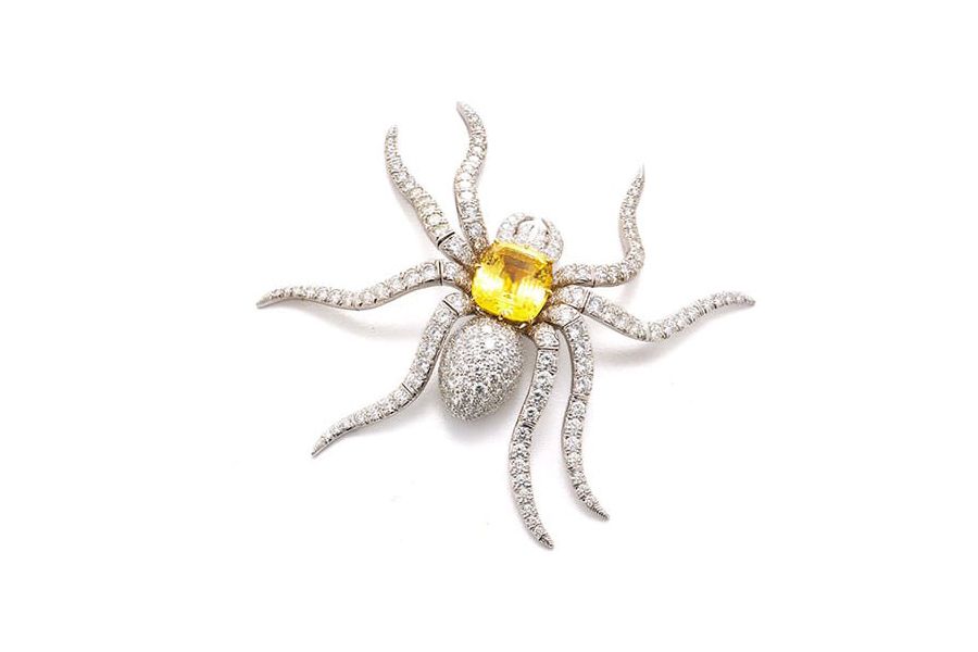 Spider brooch in platinum and gold, set with brilliant-cut diamonds and a cushion cut yellow-sapphire
